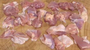 Raw chicken thigh cut into bite-sized pieces