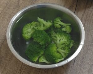 Blanched broccoli florets in an ice bath