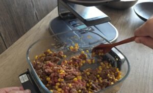 Stirring and breaking up the half-cooked minced beef in the air fryer dish