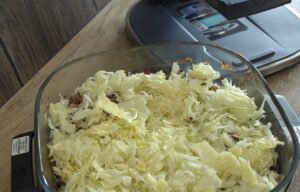Shredded cabbage layered over the cooked soy garlic beef in the air fryer dish