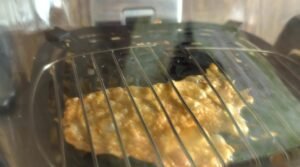 Chicken skin crisping flat on the air fryer crisper plate