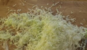 Finely shredded cabbage on a wooden board
