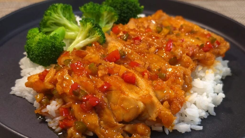 Glazed gochujang chicken over steamed rice with blanched broccoli