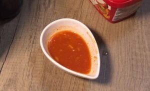 Gochujang chili dip in a small white dish