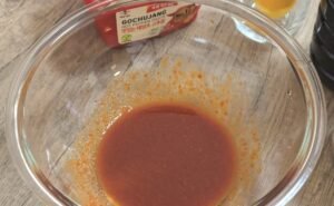 Gochujang, honey and soy sauce marinade whisked in a bowl
