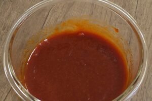 Gochujang, ketchup, soy sauce and honey marinade whisked in a glass bowl