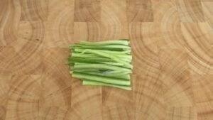 Julienned cucumber on a wooden board