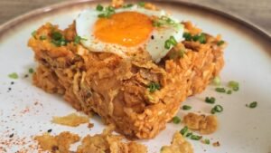 Korean gochujang chicken and cabbage rice topped with a sunny-side-up egg and crispy chicken skin
