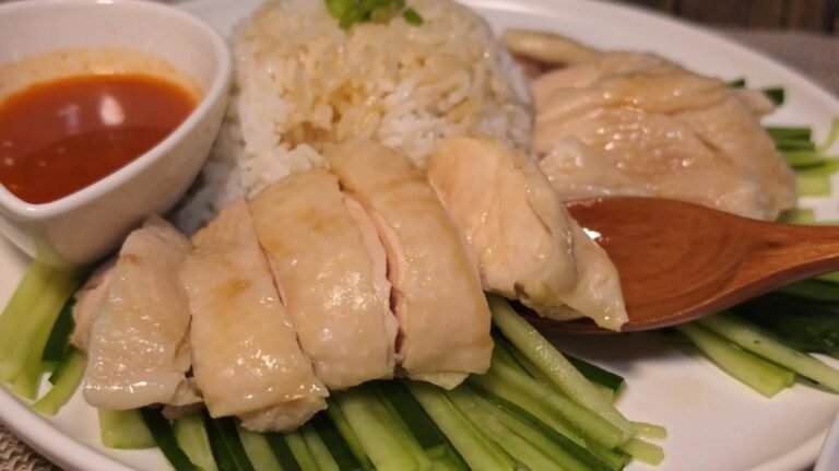 Silky poached chicken slices over jasmine rice with cucumber and gochujang chili dip