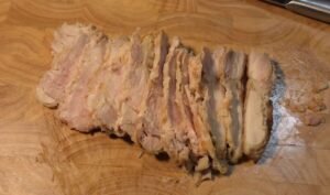 Chilled seared chicken thigh sliced into even strips