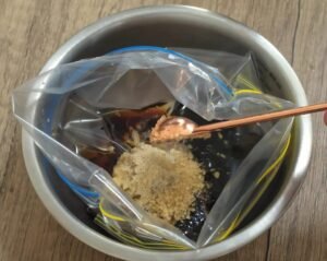 Soy and oyster sauce marinade with garlic and ginger in a bowl