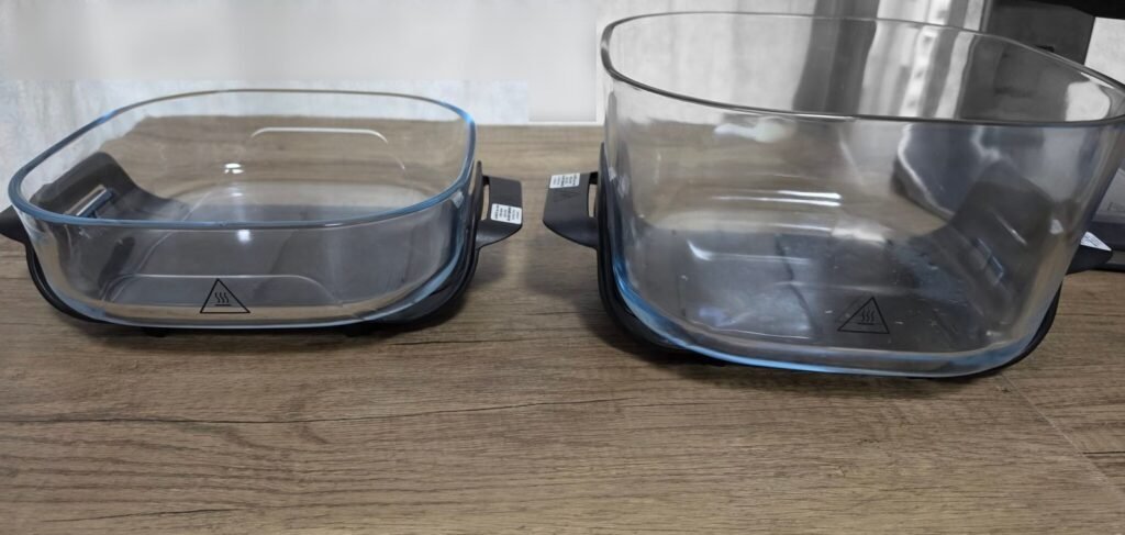 Two Ninja Crispi Pro glass air fryer containers side by side: the small container on the left and the large container on the right