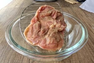 Boneless chicken thigh seasoned on the meat side with salt and pepper
